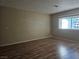 Cozy bedroom with wood floors and a bright window showcasing lots of natural light at 2116 Bavington Dr # C, Las Vegas, NV 89108