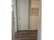 View of a hallway featuring a white door and laminate wood flooring at 2116 Bavington Dr # C, Las Vegas, NV 89108