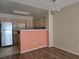 Kitchen area view with stainless steel refrigerator and bar top view into living room at 2116 Bavington Dr # C, Las Vegas, NV 89108