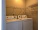 Convenient laundry room offers washer, dryer, and wire shelving for storage at 2116 Bavington Dr # C, Las Vegas, NV 89108