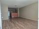 Inviting living room features open layout, wood flooring, and views into kitchen area at 2116 Bavington Dr # C, Las Vegas, NV 89108