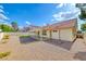 Wide view of backyard with gravel landscaping, patio, tile roof, and bright blue sky at 234 Geronimo Ct, Henderson, NV 89074