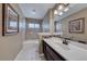 A spacious bathroom showcasing a vanity, mirror, decorative artwork and bathtub at 234 Geronimo Ct, Henderson, NV 89074