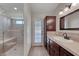 Bathroom with a walk-in shower with seat, vanity, tile floors, and outside access at 234 Geronimo Ct, Henderson, NV 89074