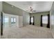 Large carpeted bedroom featuring vaulted ceilings and two large windows with dark curtains at 234 Geronimo Ct, Henderson, NV 89074