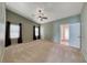 Spacious carpeted bedroom with vaulted ceilings, ceiling fan and two bright windows at 234 Geronimo Ct, Henderson, NV 89074