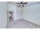 This bedroom features carpet floors, a double-door closet, and entry to the ensuite bathroom at 234 Geronimo Ct, Henderson, NV 89074