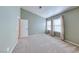 Carpeted bedroom featuring two bright windows and an en-suite bathroom at 234 Geronimo Ct, Henderson, NV 89074