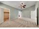 Spacious carpeted bedroom with vaulted ceilings and adjacent closet and bathroom at 234 Geronimo Ct, Henderson, NV 89074