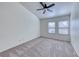 This bedroom features carpet floors, two windows, and a ceiling fan with overhead lighting at 234 Geronimo Ct, Henderson, NV 89074