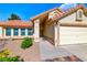 Close-up exterior of home featuring a two-car garage, desert landscaping and tile roof at 234 Geronimo Ct, Henderson, NV 89074