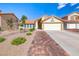Charming single-story home with a two-car garage, tile roof, and desert landscaping at 234 Geronimo Ct, Henderson, NV 89074