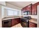 Well-equipped kitchen with dark cabinets, and granite countertops at 234 Geronimo Ct, Henderson, NV 89074