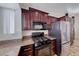Kitchen featuring stainless steel appliances and dark cabinets at 234 Geronimo Ct, Henderson, NV 89074