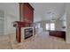 Cozy living room with a tiled fireplace and an open kitchen area at 234 Geronimo Ct, Henderson, NV 89074