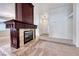 Spacious living room featuring plush carpeting and a charming fireplace focal point at 234 Geronimo Ct, Henderson, NV 89074