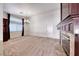 Expansive living room offering plush carpets, natural light, and a cozy fireplace at 234 Geronimo Ct, Henderson, NV 89074