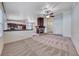 Open-concept floorplan featuring a cozy living room with fireplace and a kitchen island at 234 Geronimo Ct, Henderson, NV 89074