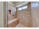 Close up of bathroom tile shower featuring a seat and a shower niche at 234 Geronimo Ct, Henderson, NV 89074