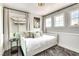 Bright bedroom with natural light, stylish decor, and multiple windows for a warm, inviting space at 2429 Worchester Rd, Henderson, NV 89074
