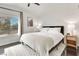Serene bedroom with neutral tones, large window, and stylish bedside tables with lamps at 2429 Worchester Rd, Henderson, NV 89074