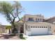 Charming two-story home with a well-maintained yard, red door and a two car garage at 2429 Worchester Rd, Henderson, NV 89074