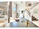 Bright and airy living room with high ceilings, large windows, and elegant staircase at 2429 Worchester Rd, Henderson, NV 89074