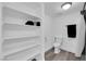 Clean bathroom with a toilet, shower, and built-in shelving for storage at 2661 Ruthe Duarte Ave, Las Vegas, NV 89121