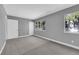 Gray-walled bedroom with carpet, two windows, and white doors at 2661 Ruthe Duarte Ave, Las Vegas, NV 89121
