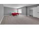 Spacious carpeted bedroom with a red blanket on the bed and a closet at 2661 Ruthe Duarte Ave, Las Vegas, NV 89121