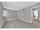 Carpeted bedroom featuring gray walls and a view into an adjoining room at 2661 Ruthe Duarte Ave, Las Vegas, NV 89121