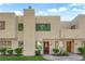 A view of the townhouse exterior featuring a well-manicured lawn and desert landscaping at 2661 Ruthe Duarte Ave, Las Vegas, NV 89121