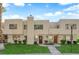 Inviting townhouse featuring a manicured lawn, desert landscaping and neutral color scheme at 2661 Ruthe Duarte Ave, Las Vegas, NV 89121