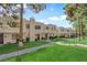 Well-maintained townhouses featuring sidewalks, manicured lawns, mature trees and desert landscaping at 2661 Ruthe Duarte Ave, Las Vegas, NV 89121