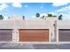Exterior shot of a modern home featuring an attached garage and desert landscaping at 2661 Ruthe Duarte Ave, Las Vegas, NV 89121