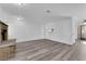 Cozy living room with a brick fireplace, updated flooring, and fresh white walls at 2661 Ruthe Duarte Ave, Las Vegas, NV 89121