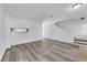 Spacious living room featuring fresh paint, updated flooring, an open staircase and modern lighting at 2661 Ruthe Duarte Ave, Las Vegas, NV 89121