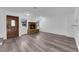 Charming living room with a brick fireplace, updated flooring, a custom front door and natural light at 2661 Ruthe Duarte Ave, Las Vegas, NV 89121
