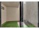 Covered patio with artificial turf, a sliding glass door, and a view of the interior at 2661 Ruthe Duarte Ave, Las Vegas, NV 89121