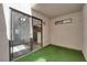 Enclosed patio with artificial turf, a sliding glass door, and access to the kitchen at 2661 Ruthe Duarte Ave, Las Vegas, NV 89121