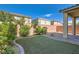 Manicured backyard featuring artificial grass and a stone perimeter at 2806 Calle Cadiz, Henderson, NV 89044