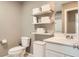 Well-lit bathroom with a toilet, vanity, shelving, and storage options at 2806 Calle Cadiz, Henderson, NV 89044