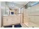 Bright bathroom featuring double vanity, decorative lighting and a glass-enclosed shower at 2806 Calle Cadiz, Henderson, NV 89044