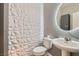 Stylish powder room featuring modern 3D accent wall, toilet and sink at 2806 Calle Cadiz, Henderson, NV 89044