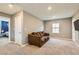 Spacious bonus room featuring a sofa, carpet flooring, and natural light at 2806 Calle Cadiz, Henderson, NV 89044