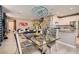 Modern dining area featuring stylish chandelier, glass table and views into the bright kitchen at 2806 Calle Cadiz, Henderson, NV 89044