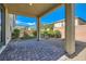 Covered patio with stone pavers and low maintenance rock landscaping at 2806 Calle Cadiz, Henderson, NV 89044