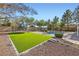 Well-maintained backyard with artificial turf, a sparkling pool, and ample space for outdoor activities at 313 Glenridding St, Las Vegas, NV 89183