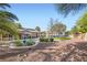 Expansive backyard featuring a sparkling pool, lush greenery, and a charming patio area, ideal for relaxation at 313 Glenridding St, Las Vegas, NV 89183