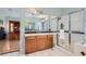 Elegant bathroom featuring a glass-enclosed shower, soaking tub, double sinks, and a seamless transition to the main bedroom at 313 Glenridding St, Las Vegas, NV 89183